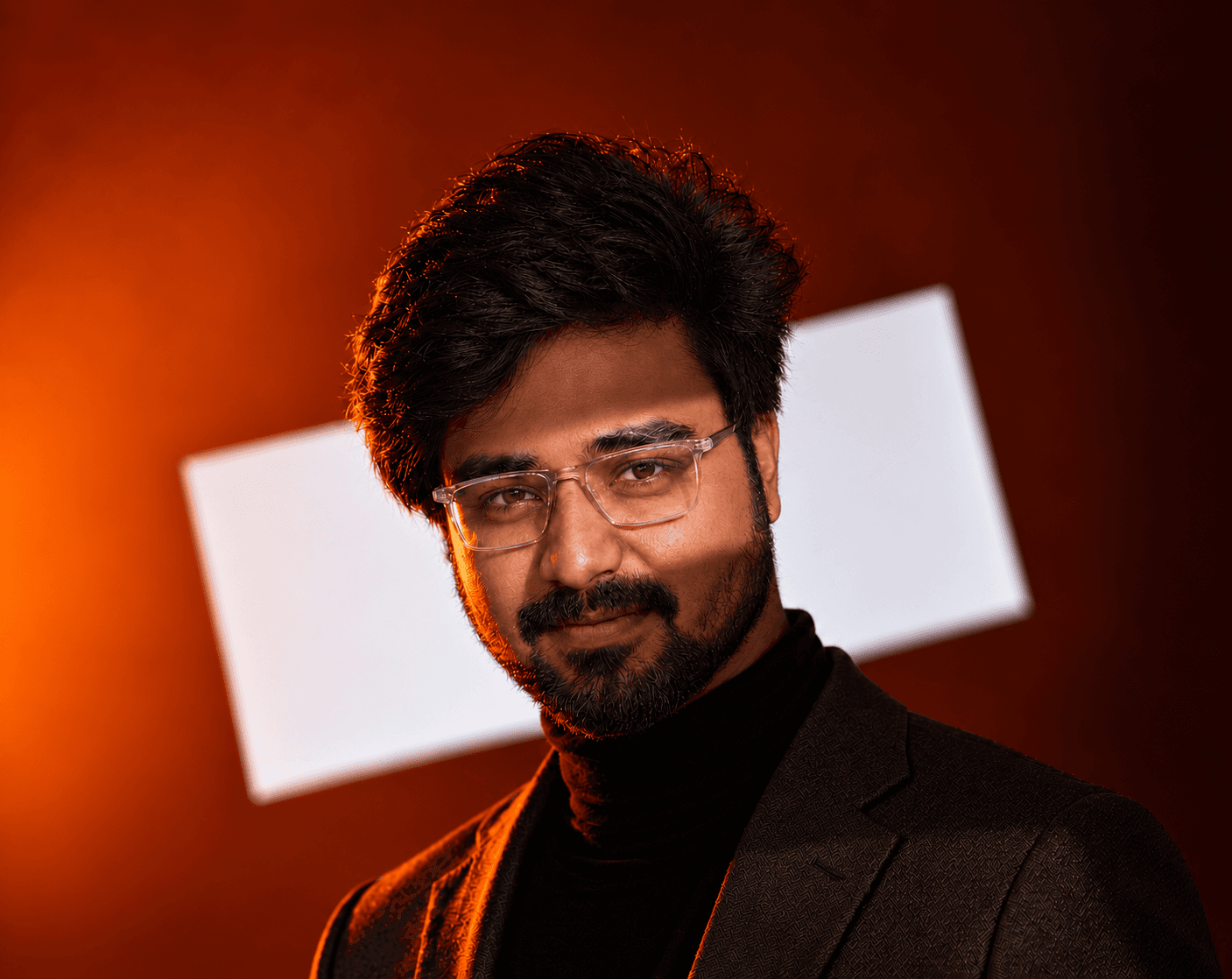 Portrait of Muthukumar G, software developer, lit by warm red cinematic light